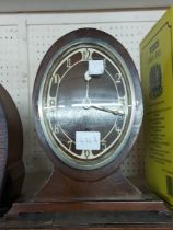 A vintage stained walnut cased drum mantel timepiece with eight day movement