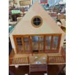 A vintage doll's house - sold with a box of accessories