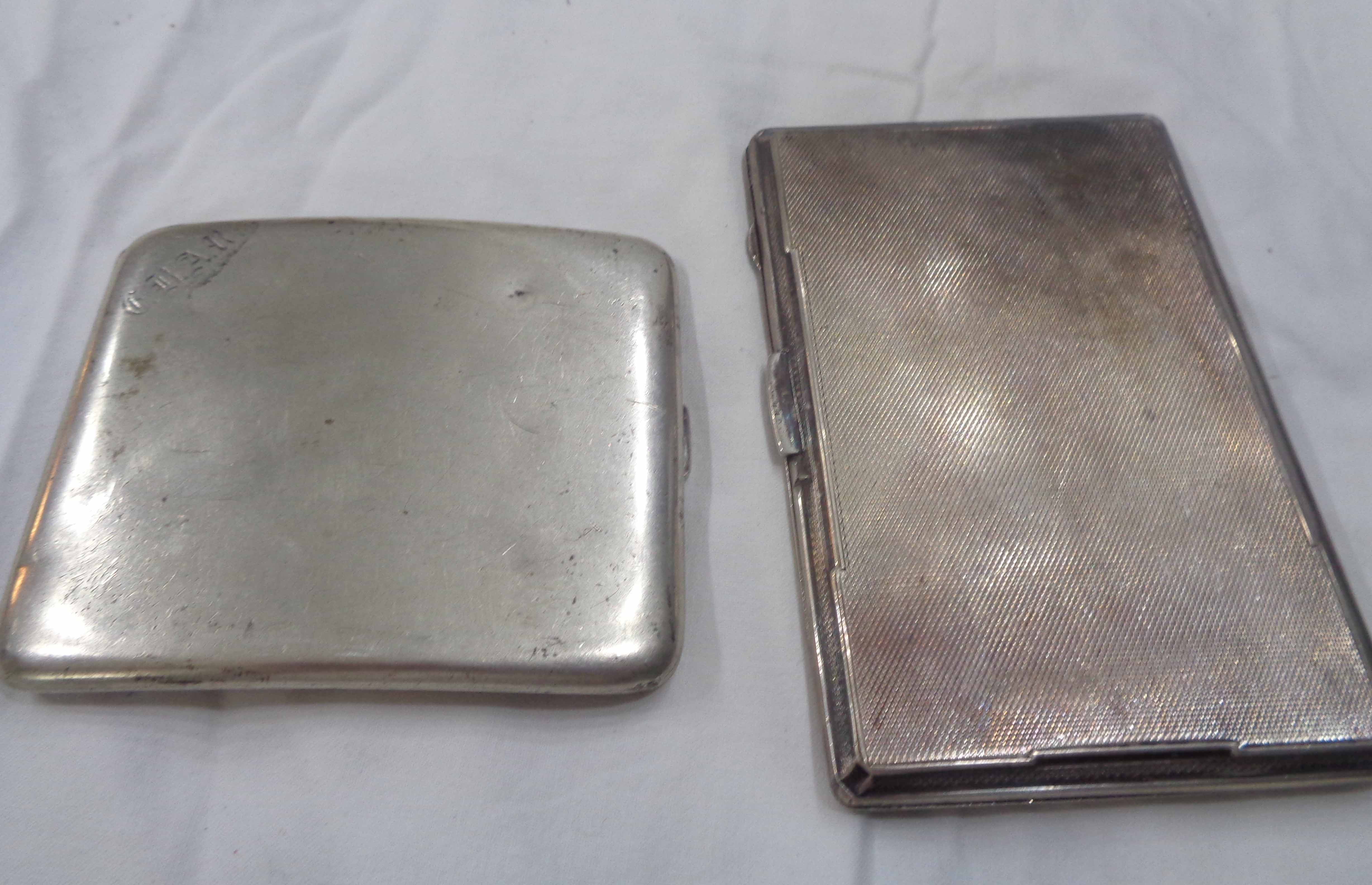 Two silver cigarette cases comprising one with engine turned decoration and internal initials, the