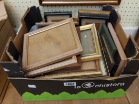 A box containing a large selection of vintage and other small picture frames, some with images