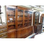 A 2.1m reproduction mahogany two part break front book cabinet with shelves enclosed by two pairs of