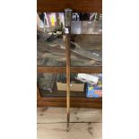 An old walking stick with decorative white metal embossed top