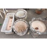 Five concrete garden pots and planters