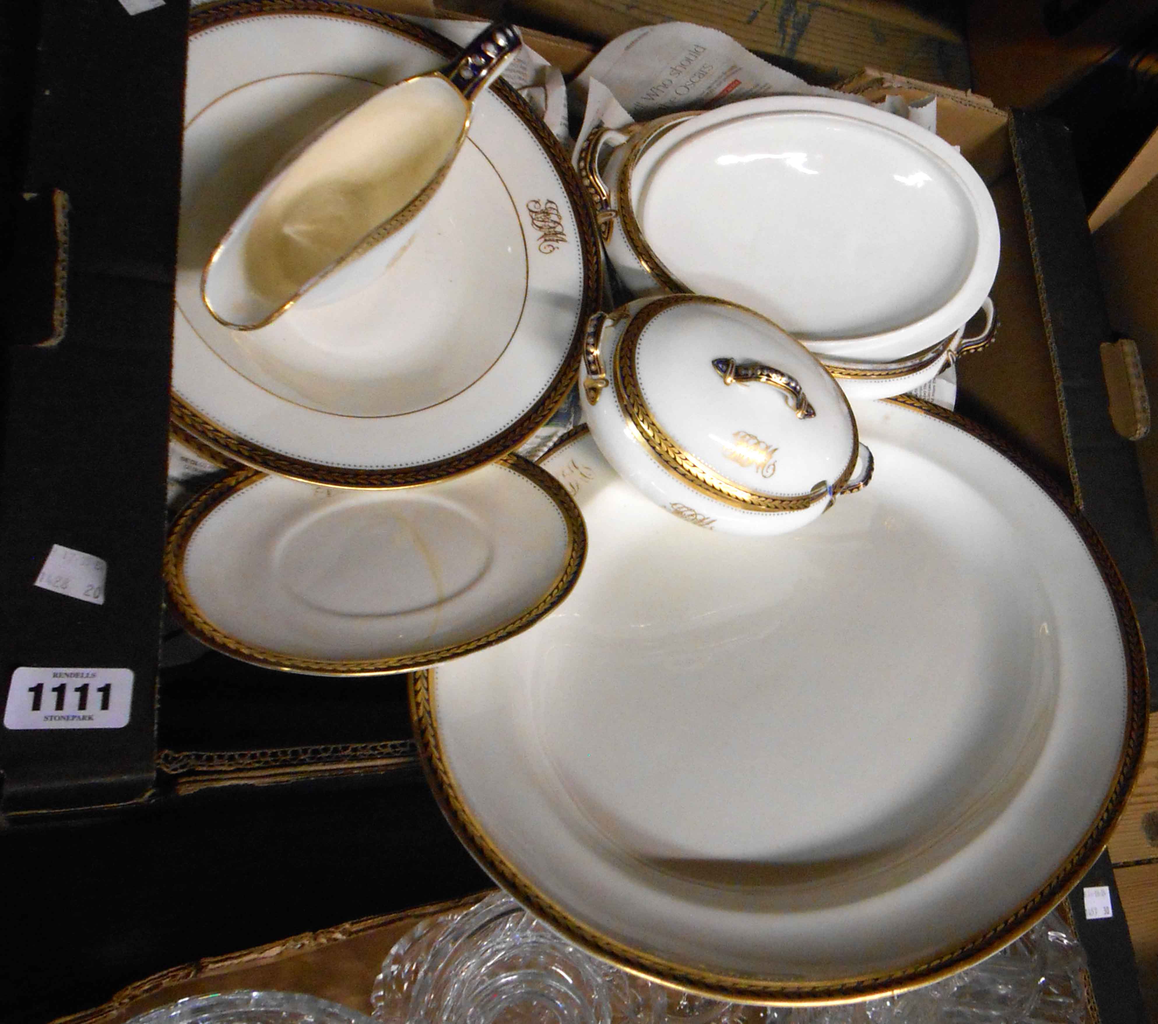 A box containing a quantity of George Jones bone china dinner ware, decorated with a simple gilt and