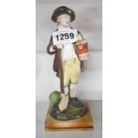 An antique pearlware Staffordshire figure, depicting a gardener holding a shovel and a potted