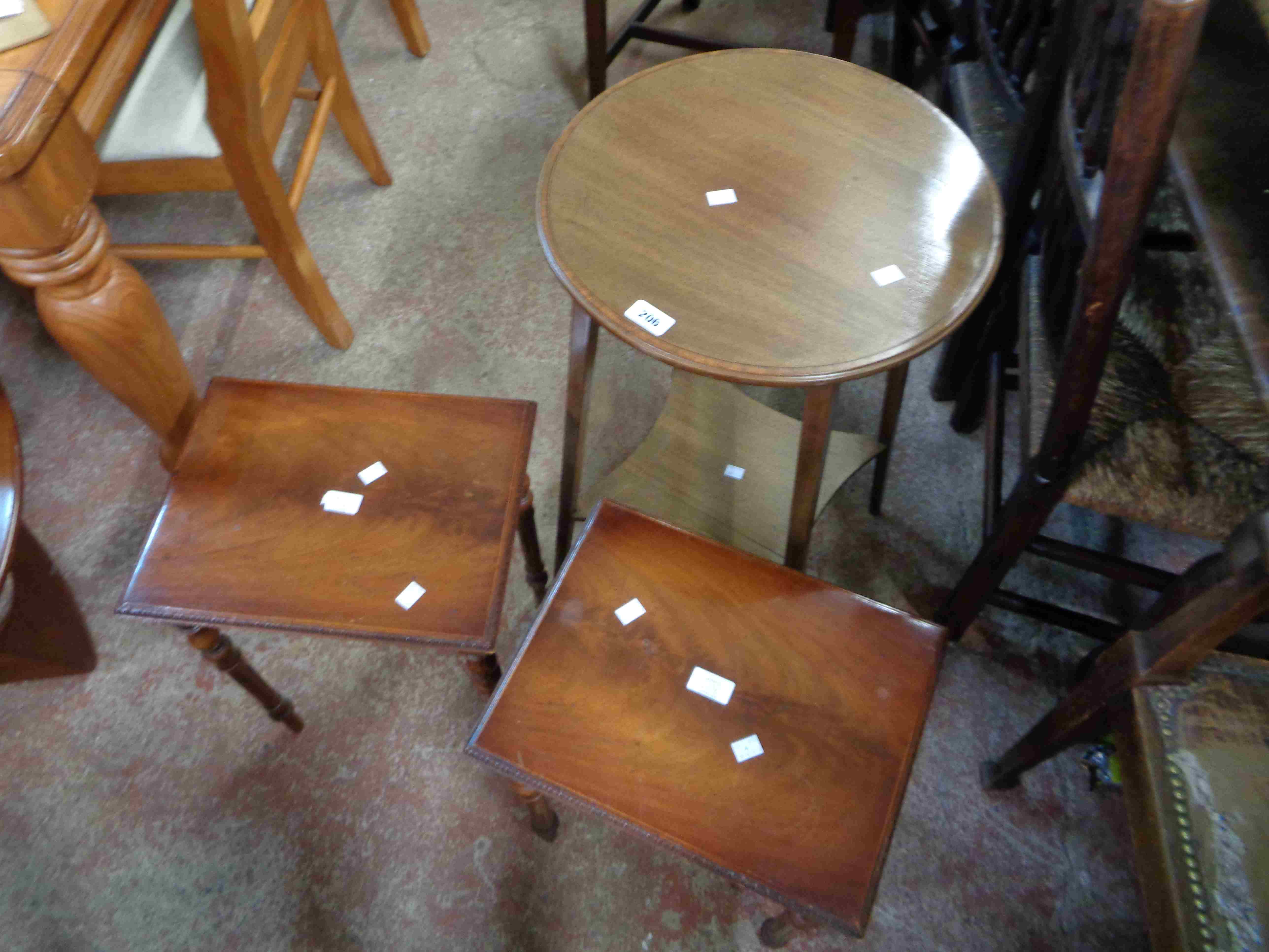 A 43cm diameter Edwardian mahogany two tier occasional table, set on slender square supports -