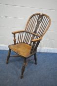 A 19TH CENTURY ELM AND BEECH WINDSOR ELBOW CHAIR, with spindle back and central splat, on turned