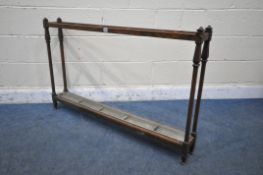 A 20TH CENTURY OAK UMBRELLA/STICK STAND, with five divisions, on square supports, with a long