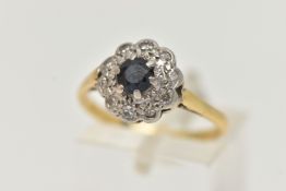 A YELLOW METAL SAPPHIRE AND DIAMOND CLUSTER RING, set with a central circular cut blue sapphire