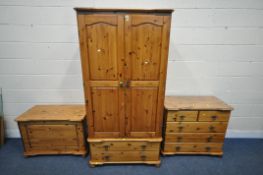 A MODERN PINE THREE PIECE BEDROOM SUITE, comprising a double door wardrobe, with two drawers,
