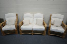 A RATTAN THREE PIECE CONSERVATORY SUITE, comprising a two seater sofa, length 136cm x depth 97cm x
