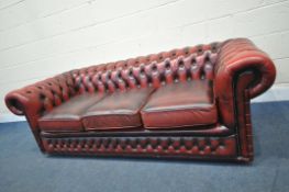 AN OXBLOOD LEATHER CHESTERFIELD BUTTONED THREE SEATER SOFA, length 200cm x depth 90cm x height