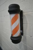 A PLASTIC ELECTRONIC RED AND WHITE STRIPED WALL HANGING BARBER POLE, height 68cm (condition