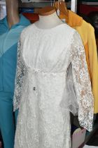 A SHOP MANNEKIN AND THREE 1970S LADIES' OUTFITS, comprising a cream long sleeved lace wedding