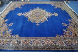 A 20TH CENTURY LOUIS DE POORTERE KANDAHAR WORSTED WOOL RUG, with a blue field, central medallion and