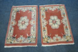 A PAIR OF SMALL CHINESE WOOLEN RUGS, 92cm x 60cm (condition report: some discoloration and usage) (