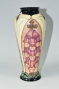 A MOORCROFT POTTERY 'FOXGLOVE' PATTERN TRIAL VASE, of elongated shouldered form, tube lined with