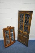 AN OLD CHARM OAK CORNER CUPBOARD, the double glazed doors enclosing two fixed shelves, above two