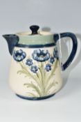 A WILLIAM MOORCROFT FOR MACINTYRE 'FLORIAN WARE' HOT WATER JUG AND COVER, in Blue Poppies pattern,