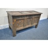 A GEORGIAN OAK COFFER, with a hinged lid, the front panels with scrolled and foliate carvings, width