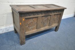 A GEORGIAN OAK COFFER, with a hinged lid, the front panels with scrolled and foliate carvings, width