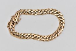 A 9CT GOLD CURB LINK BRACELET, hollow links, fitted with a push piece, integrated clasp, with figure