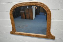 A PINE OVERMANTEL MIRROR, with a domed top and foliate decoration, width 130cm x height 90cm (
