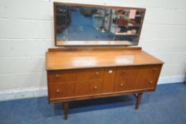 A MID CENTURY TEAK DRESSING TABLE, with a single rectangular mirror, above four drawers, on