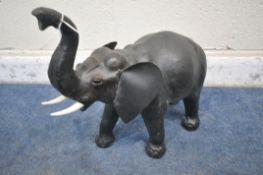 IN THE MANNER OF LIBERTY OF LONDON, A SMALL LEATHER FIGURE OF A BELLOWING ELEPHANT, height 48cm (