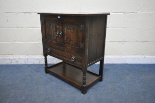 A JAYCEE OAK CABINET, with two linenfold doors, above a single drawer, on turned front legs,