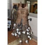 AN AUTUMNUL WICKER DISPLAY MANNEQUIN, on a rustic wooden stand, wicker bodice and tree branch and
