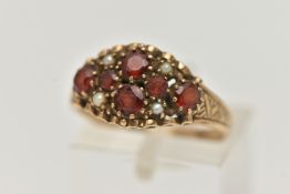 A 9CT GOLD GARNET AND SPLIT PEARL RING, set with six circular cut garnets and four split pearl