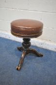 A VICTORIAN WALNUT PIANO STOOL, with brown leather studded upholstery, on a turned support and three