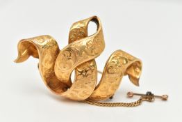 A LATE 19TH CENTURY YELLOW METAL BROOCH, of interwoven ribbon design with scroll embossed detail,