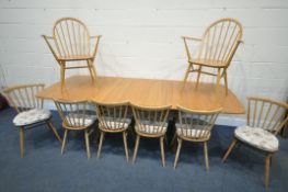 AN ERCOL ELM EXTENDING DINING TABLE, with three additional leaves, extended length 252cm closed