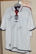 A SIGNED REPLICA ENGLAND MEN'S FOOTBALL SHIRT, signatures of David Beckham, Michael Owen and Sven