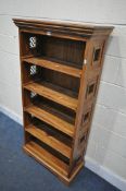 A HARDWOOD OPEN BOOKCASE, with four shelves and metal panels to the sides, width 74cm x depth 34cm x