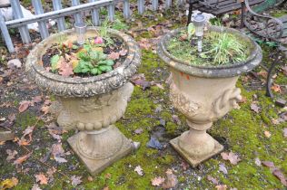 TWO COMPOSITE CAMPAGNA GARDEN URNS, one with twin mask effect handles height 85cm, the other with