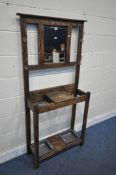 A 20TH CENTURY OAK HALL STAND, with four brass hooks, surrounding a rectangular bevelled edge