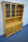 A MODERN QUALITY ASH DRESSER, fitted with an arrangement of shelving, two lead glazed doors and four