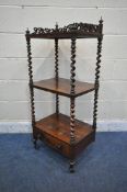 A VICTORIAN ROSEWOOD THREE TIER WHATNOT, with a scrolled pierced gallery top, barley twist supports,