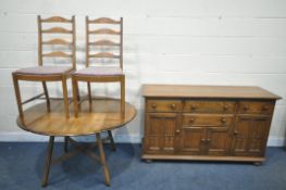 AN ERCOL ELM AND BEECH CANTERBURY SIDEBOARD, fitted with an arrangement of four drawers and doors,