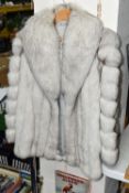 A FAULKES OF EDGBASTON FUR JACKET, size M, white fur with fine brown tips, together with a very