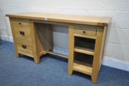 A SOLID LIGHT OAK KNEE HOLE DESK, fitted with an arrangement of four drawers and a single shelf,