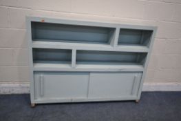 A 20TH CENTURY LIGHT BLUE PAINTED BOOKCASE, with two sliding doors, on later castors, width 138cm