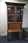 AN EARLY 20TH CENTURY WALNUT BUREAU BOOKCASE, the double bevelled glass doors enclosing an