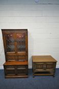 AN OLD CHARM OAK BOOKCASE, the two lead glazed doors enclosing two adjustable glass shelves, a