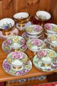 A SET OF EIGHT TAYLOR & KENT FLORAL TEA CUPS AND NINE SAUCERS, pale green ground decorated with pink