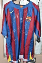 A SIGNED BARCELONA REPLICA HOME FOOTBALL SHIRT, signed by Ronaldinho, Etoo, Puyol, Deco, Valdes,