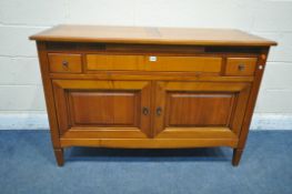 A REPRODUCTION CHERRYWOOD SIDEBOARD, fitted with a revolving pen tidy, two drawers flanking a